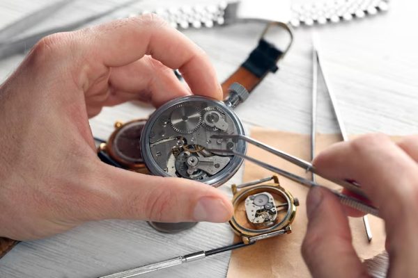watchmaker-hands-repairing-mechanism-old-watch-closeup_392895-398194 (1)